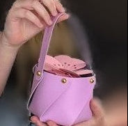 image of child holding lilac tote pouch