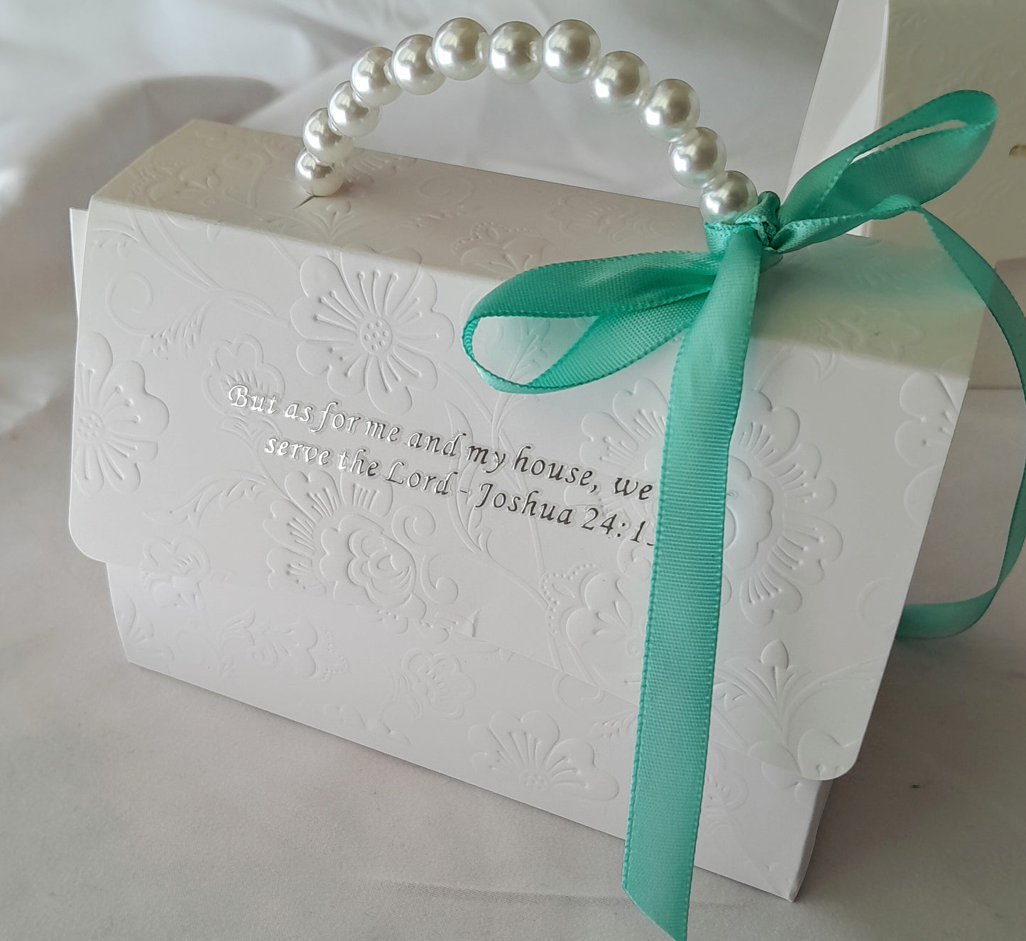 White  embossed decorative gift box with pearl handle and aqua ribbon 