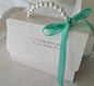 White  embossed decorative gift box with pearl handle and aqua ribbon 