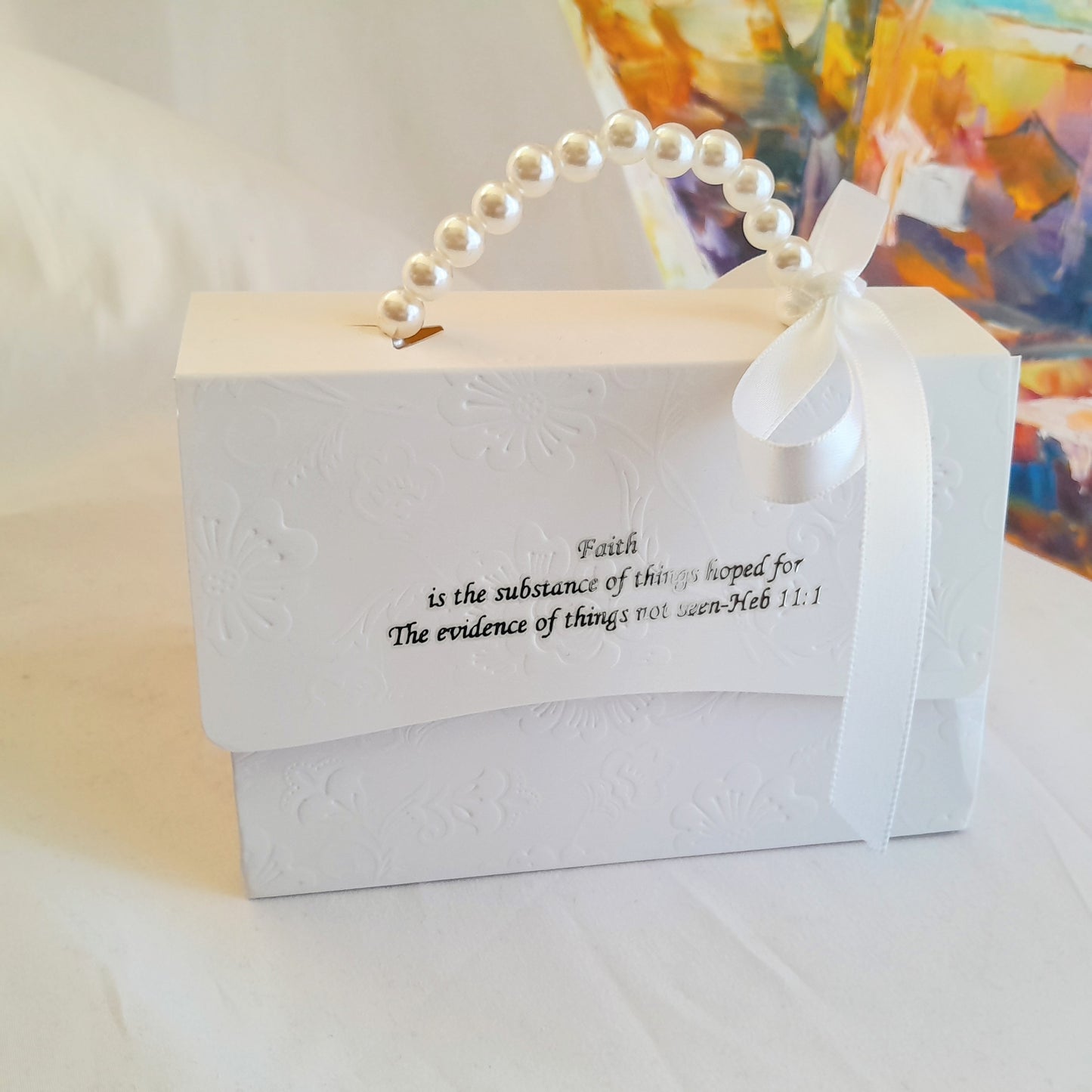 White  embossed decorative gift box with pearl handle and white ribbon 